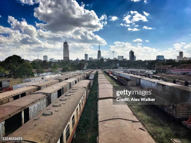 abandoned railway yard with trains and urban skyline - nairobi city stock pictures, royalty-free photos & images