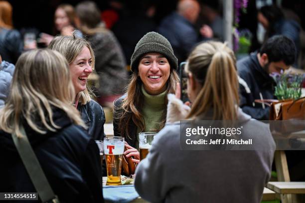 Members of the public enjoy a drink at the Three Sisters Pub in the Cowgate as lockdown measures are eased on April 26, 2021 in Edinburgh, United...