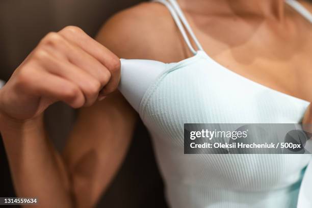 close-up of young woman removing padding from bra - padding stock pictures, royalty-free photos & images