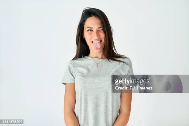 portrait of woman sticking out tongue on white background - brown hair isolated stock pictures, royalty-free photos & images