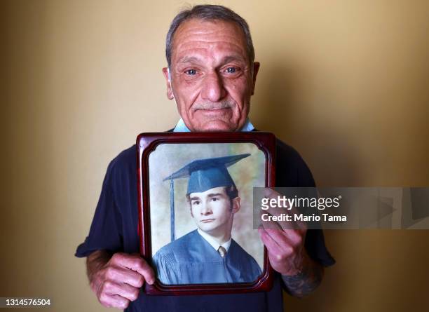 Mario Frausto holds a high school graduation photo of his deceased husband Terrance Sheppard, who passed away on March 25 due to complications from...