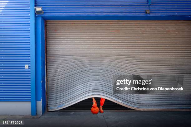 silver rolling gate with ball and heels - shop shutter stock pictures, royalty-free photos & images