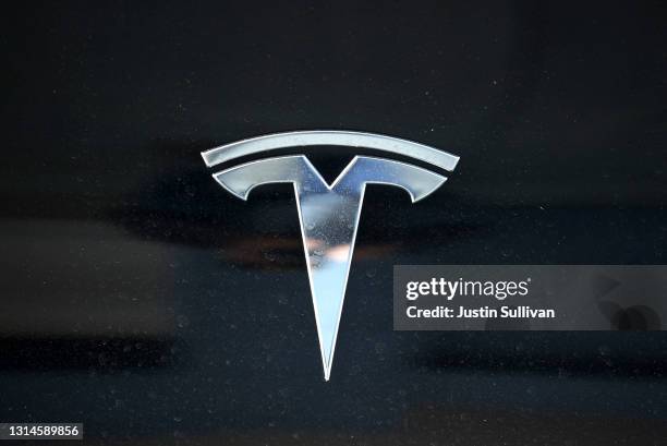 The Tesla logo is displayed on a Tesla car on April 26, 2021 in Corte Madera, California. Tesla will report first quarter earnings today after the...