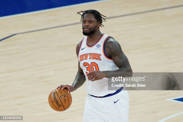 Julius Randle of the New York Knicks dribbles during the second half against the Charlotte Hornets at Madison Square Garden on April 20, 2021 in New...