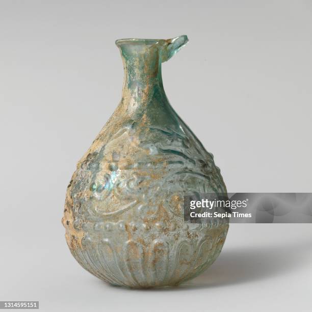 Glass hunt-and-scroll bottle, Early Imperial, 1st century A.D., Roman, Glass; blown in a two-part mold, H.: 3 7/8 x 2 5/8 x 7/8 in. , Glass,...