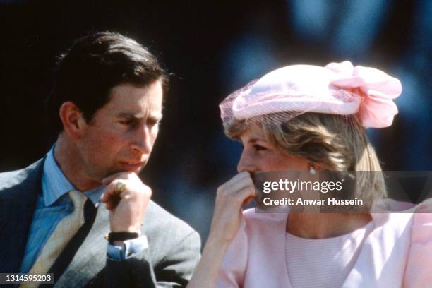 Prince Charles, Prince of Wales and Diana, Princess of Wales, wearing a pale pink dress designed by Catherine Walker with a matching archer style...