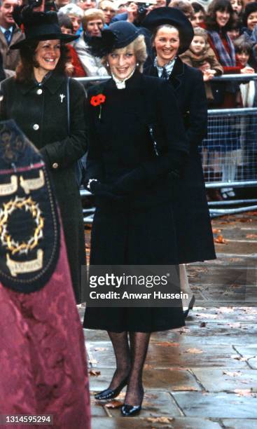Diana, Princess of Wales, wearing a black coat with a black hat with netting and ostrich feathers, a remembrance poppy and patterned tights, arrives...