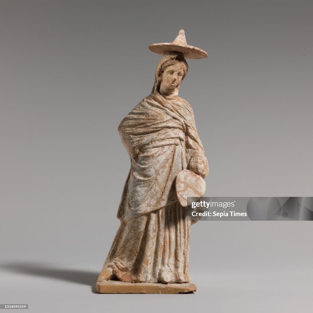 Terracotta statuette of a woman, Hellenistic, 3rd century B.Greek, Boeotian, Terracotta, H.: 7 1/2 in. (19.1 cm), Terracottas, Standing, draped girl, wearing hat, fan held down in left hand, right hand behind her.