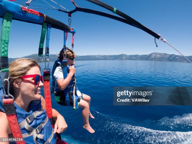 parasailing in lake tahoe - parascending stock pictures, royalty-free photos & images