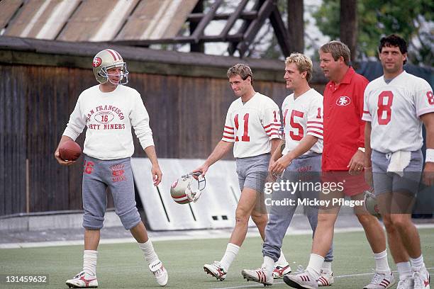 San Francisco 49ers QB Joe Montana , QB Bob Gagliano , RB John Paye , coach Mike Holmgren, and QB Steve Young during practice session at Red Morton...