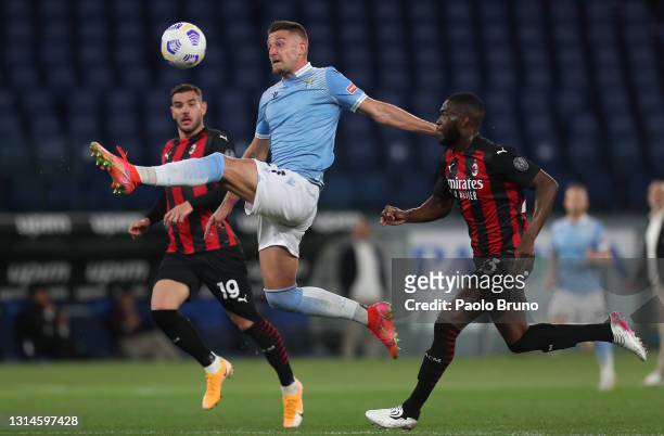 Sergej Milinkovic-Savic of SS Lazio controls the ball while under pressure from Fikayo Tomori of A.C. Milan during the Serie A match between SS Lazio...