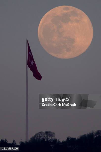 An almost full pink super moon rises over Istanbul on April 26, 2021 in Istanbul, Turkey. The pink super moon is the first of two super moons which...