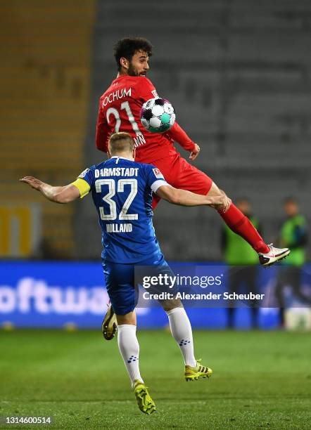 Gerrit Holtmann of VfL Bochum 1848 heading the ball ahead of Fabian Holland of SV Darmstadt 98 during the Second Bundesliga match between SV...