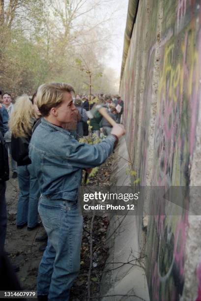 Berliners and visitors from all over the world come to enjoy their recently-found freedom and try to take a little piece of the Wall.