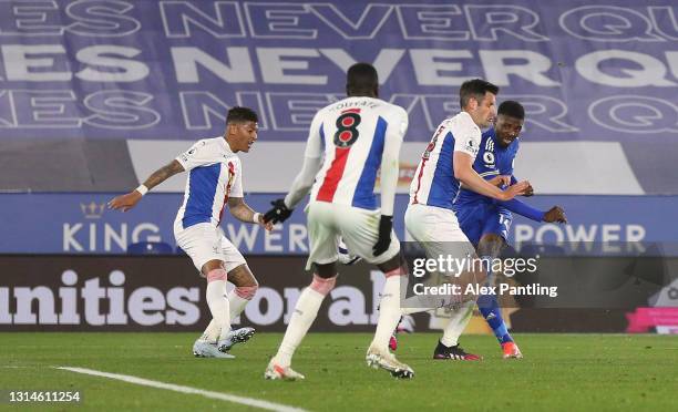 Kelechi Iheanacho of Leicester City scores their team's second goal past Patrick van Aanholt and Scott Dann of Crystal Palace during the Premier...