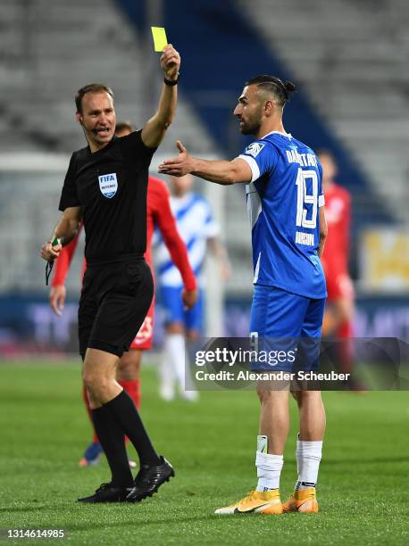 Bastian Dankert, the match referee giving a yellow card to Serdar Dursun of SV Darmstadt 98 during the Second Bundesliga match between SV Darmstadt...