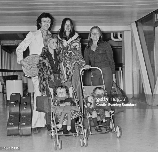 Scottish singer Donovan Leitch with his wife Linda Lawrence at Heathrow Airport in London, UK, 25th February 1974. They are accompanied by Linda's...
