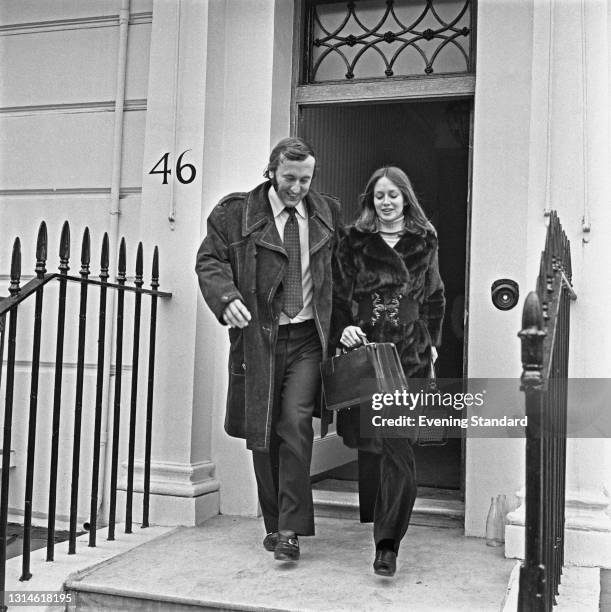 British television host and journalist David Frost leaves home with American model Karen Graham, UK, 6th March 1974.