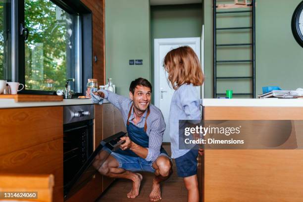 father and son baking cake and bonding - fathers day lunch stock pictures, royalty-free photos & images