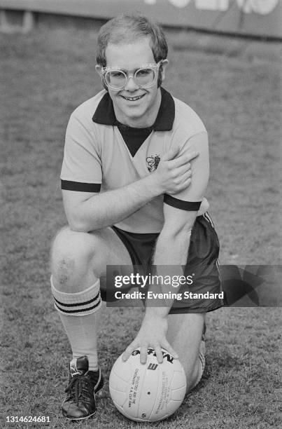 English singer, composer and pianist Elton John wearing a Watford football strip at Watford FC's Vicarage Road stadium, Watford, UK, 5th April 1974....