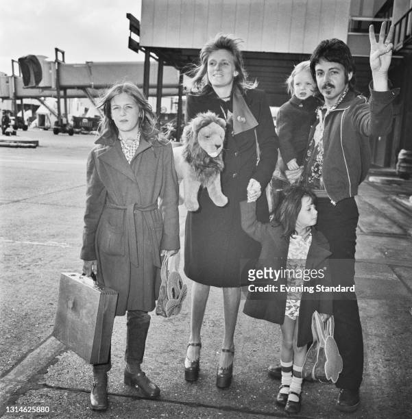 English musician Paul McCartney with his wife Linda and their daughters Heather , Mary and Stella at an airport, UK, 16th April 1974.