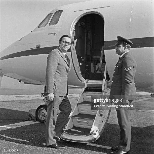 British Labour politician Merlyn Rees , the Secretary of State for Northern Ireland, boards an aircraft, UK, 4th June 1974.