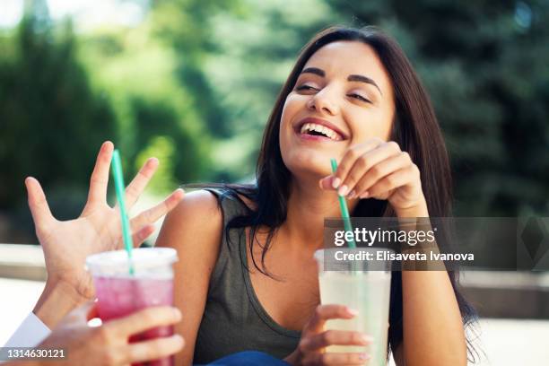 young woman laughing and drinking soda - drinking lemonade stock pictures, royalty-free photos & images