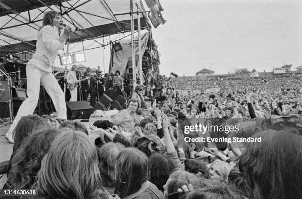 British pop singer Rod Stewart performs at a benefit concert hosted by Elton John for Watford FC at the club's Vicarage Road stadium, Watford, UK,...