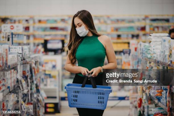 woman doing shopping at the pharmacy - pharmacy mask stock pictures, royalty-free photos & images