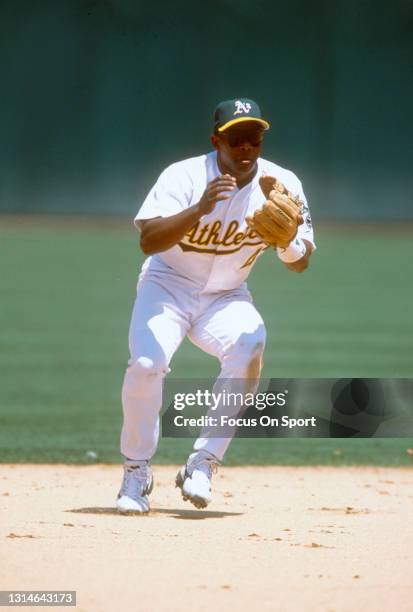 Miguel Tejada of the Oakland Athletics reacts to field the ball during an Major League Baseball game circa 2001 at the Oakland-Alameda County...