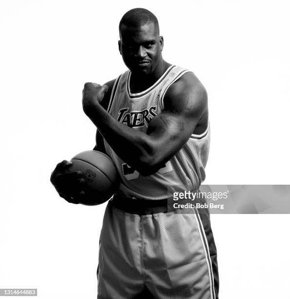 Basketball player Shaquille O'Neal of the Los Angeles Lakers poses for a portrait as he shows off his muscles and tattoos circa October, 1999 in Los...