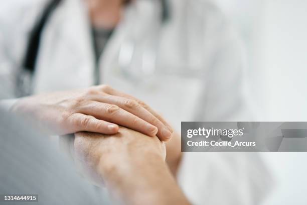 cropped shot of an unrecognizable female doctor consoling a male patient during a checkup in the hospital - consoling stock pictures, royalty-free photos & images