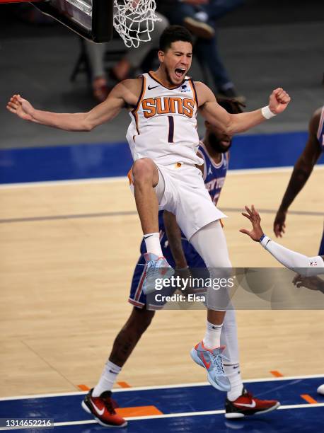 Devin Booker of the Phoenix Suns celebrates his dunk in the third quarter against the New York Knicks at Madison Square Garden on April 26, 2021 in...