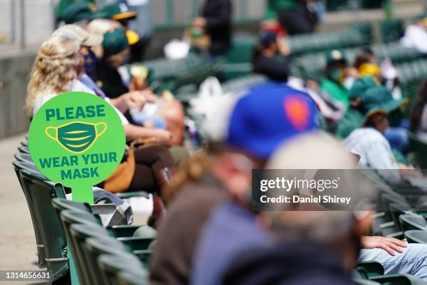 Detailed view of a sign reminding fans to wear masks during the game between the Oakland Athletics and Minnesota Twins at RingCentral Coliseum on...