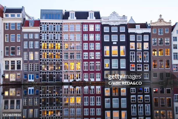 Reflections of Amsterdam's traditional buildinds on canals, Amsterdam, the Netherlands, Europe.