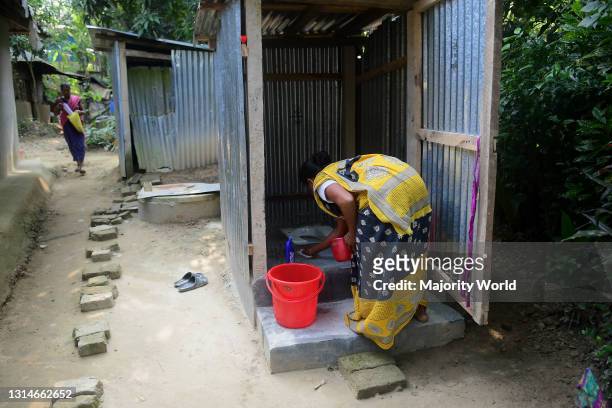Agartala, Tripura, India. 20th November 2020. A villager cleans her toilet for a project initiated by the government under the theme MISSION 100 in...