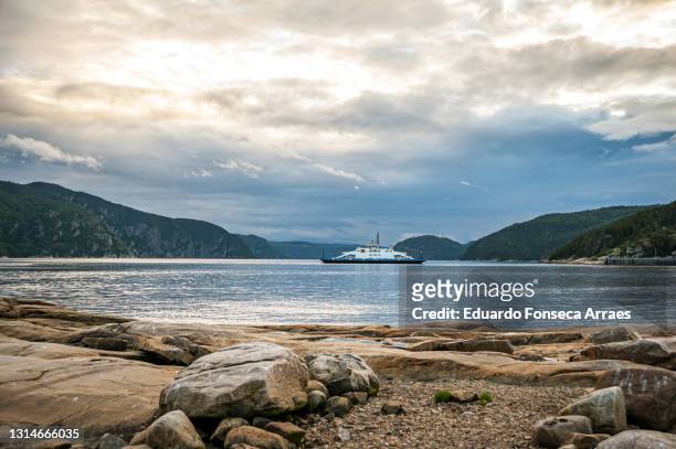 a ferry crossing and view of the waters of the gulf of saint-lawrence meeting the saguenay river and the fjords of the saguenay - golfo de san lorenzo fotografías e imágenes de stock