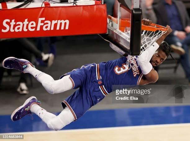 Nerlens Noel of the New York Knicks hangs on the net after a dunk in the first quarter against the Phoenix Suns at Madison Square Garden on April 26,...