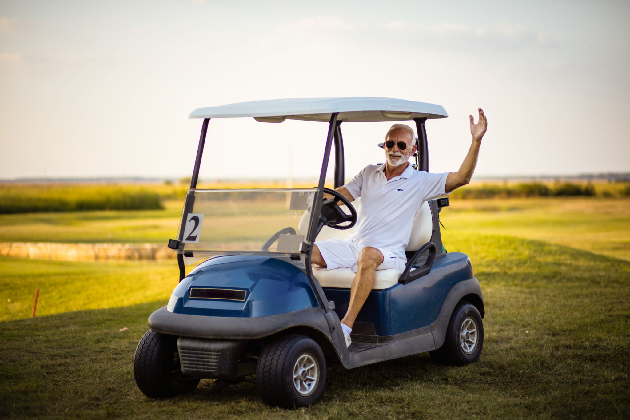 A man arrives at a golf course. A man arrives at a golf course.