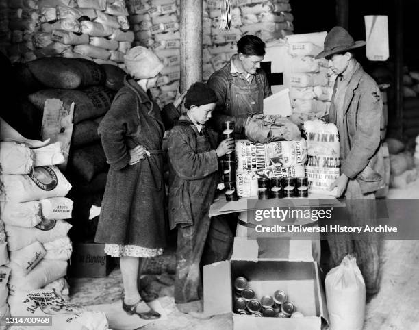 Farmer, his Wife and Son, Drought Victims, receiving well-balanced Food Order from American Red Cross at Wholesale Grocery Warehouse, Paintsville,...