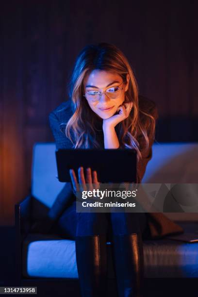 content stylish lady with tablet on couch - explicit content stock pictures, royalty-free photos & images