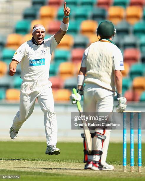 Jayde Herrick of the Bushrangers takes the wicket of George Bailey of the Tigers during day two of the Sheffield Shield match between the Tasmania...