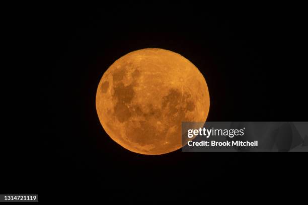 The pink super moon rises over Bondi Beach on April 27, 2021 in Sydney, Australia. The pink super moon is the first of two super moons which will be...