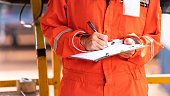 Writing note on paper - Audit and inspection in oil field operation.