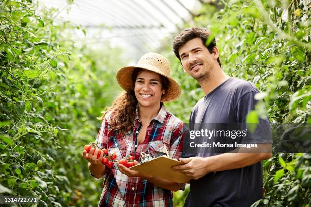 smiling farm workers with fruits and clipboard - agronomist stock pictures, royalty-free photos & images