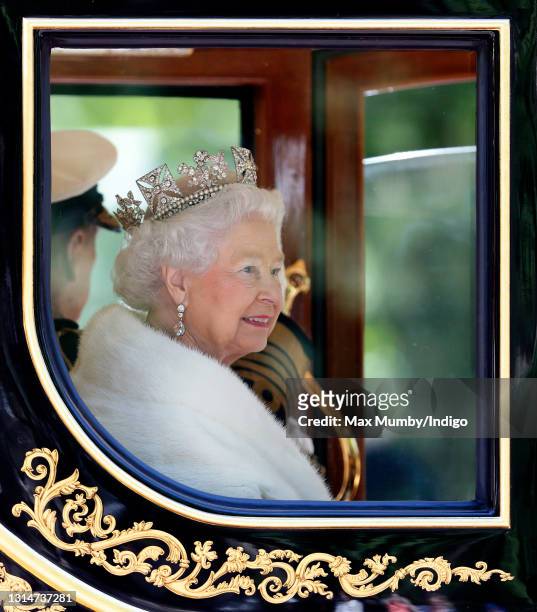Queen Elizabeth II travels down The Mall in the Diamond Jubilee State Coach after attending the State Opening of Parliament on May 27, 2015 in...