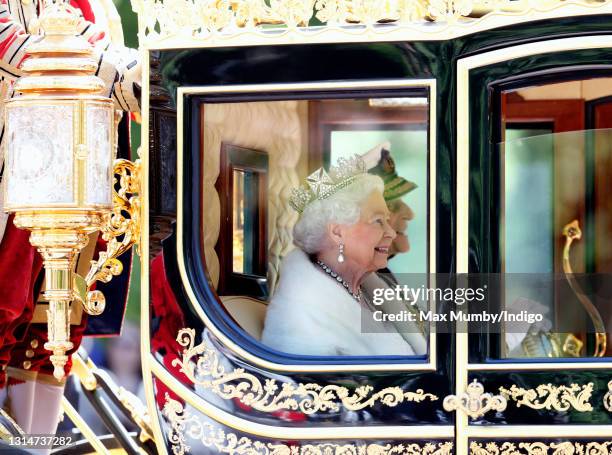 Queen Elizabeth II , accompanied by Prince Philip, Duke of Edinburgh, travels down The Mall in the Diamond Jubilee State Coach after attending the...