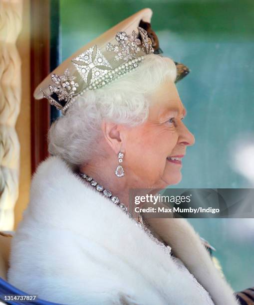 Queen Elizabeth II travels down The Mall in the Diamond Jubilee State Coach after attending the State Opening of Parliament on May 27, 2015 in...