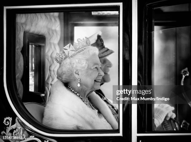 Queen Elizabeth II , accompanied by Prince Philip, Duke of Edinburgh, travels down The Mall in the Diamond Jubilee State Coach after attending the...