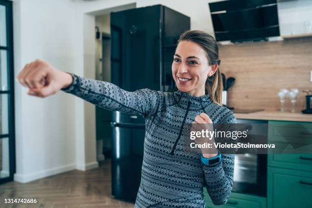 sporty woman exercising at home. - punch stock pictures, royalty-free photos & images